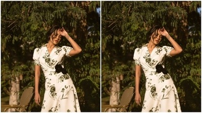 Esha looked ethereal in the white long summer dress featuring floral patterns in shades of dark green. (Instagram/@egupta) Esha looked ethereal in the white long summer dress featuring floral patterns in shades of dark green. (Instagram/@egupta)