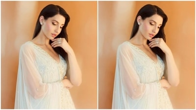 Nora looked every bit gorgeous in the white sleeveless short kurta designed in intricate embroidery work, and added a white skirt with the same pattern. Nora added more ethnic vibes to her look with a white stain dupatta featuring zari work at the borders. (Instagram/@norafatehi) Nora looked every bit gorgeous in the white sleeveless short kurta designed in intricate embroidery work, and added a white skirt with the same pattern. Nora added more ethnic vibes to her look with a white stain dupatta featuring zari work at the borders. (Instagram/@norafatehi)