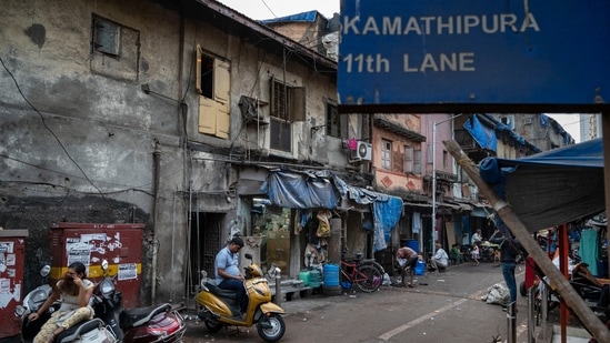 People seen in Lane number 11 in Kamathipura, Mumbai, on January 6. This month, deputy chief minister Devendra Fadnavis announced that Kamathipura, a grid of 15 lanes spread over 27.59 acres, will be gentrified under one of the largest cluster redevelopment schemes in the country.&nbsp;(Satish Bate / HT Photo)