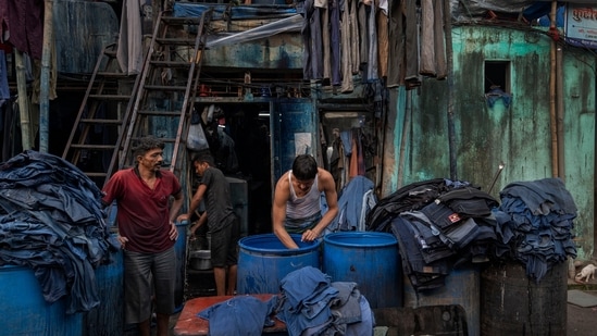 Workers seen dying clothes in the by-lanes of Kamathipura, on January 6. There are around 8,000 tenants and 4,000 land owners in Kamathipura, who live in dilapidated structures sized 40 square feet to 100 square feet. Most of the buildings are cessed, which protects tenants from rental hikes or eviction, leading to non-maintenance by landlords. At least 123 buildings in Kamathipura have been classified by MHADA as “beyond repair”, HT reported. (Satish Bate / HT Photo)