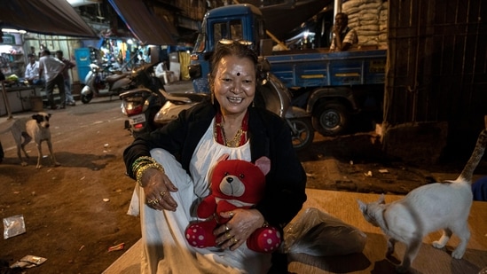 Maya, affectionately called ‘Mummy’ by sex workers, seen in the varicolored Kamathipura. A former bar girl, she helps HIV-positive women with medical assistance and rehabilitation of their orphans. “If the state government cannot do anything for their betterment, at least it should not destroy their homes and their livelihood," she told HT.(Satish Bate / HT Photo)