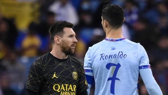 Paris Saint-Germain's Argentine forward Lionel Messi (L) walks past Riyadh All-Star's Portuguese forward Cristiano Ronaldo (R) during the Riyadh Season Cup football match 