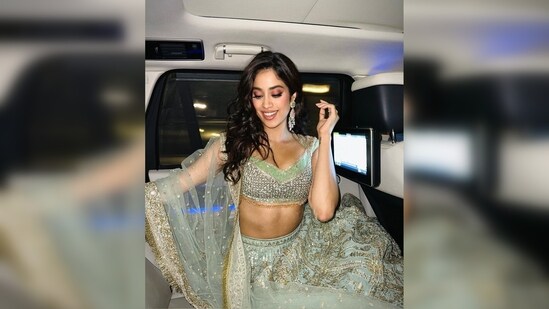 Janhvi Kapoor waved her luscious locks and left them open, pulling half of her hair to one side of her face.(Instagram/@janhvikapoor)