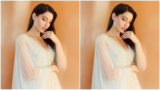 Nora looked every bit gorgeous in the white sleeveless short kurta designed in intricate embroidery work, and added a white skirt with the same pattern. Nora added more ethnic vibes to her look with a white stain dupatta featuring zari work at the borders.&nbsp;(Instagram/@norafatehi)