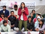 Wrestler Vinesh Phogat speaks as wrestlers Sakshi Malik and Bajrang Punia look on during their ongoing protest against the Wrestling Federation of India (WFI), at Jantar Mantar in New Delhi on Friday, (PTI) Wrestler Vinesh Phogat speaks as wrestlers Sakshi Malik and Bajrang Punia look on during their ongoing protest against the Wrestling Federation of India (WFI), at Jantar Mantar in New Delhi on Friday, (PTI)