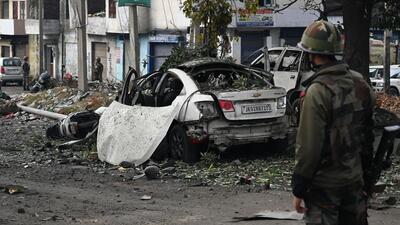 An army soldier near the car ripped apart by a blast in Narwal area of Jammu city on Saturday. (Waseem Andrabi /Hindustan Times) An army soldier near the car ripped apart by a blast in Narwal area of Jammu city on Saturday. (Waseem Andrabi /Hindustan Times)