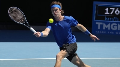 Andrey Rublev of Russia plays a forehand return to Daniel Evans of Britain during their third round match at the Australian Open tennis championship in Melbourne, Australia, Saturday, Jan. 21, 2023. (AP) Andrey Rublev of Russia plays a forehand return to Daniel Evans of Britain during their third round match at the Australian Open tennis championship in Melbourne, Australia, Saturday, Jan. 21, 2023. (AP)
