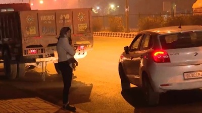 In a video clip going viral on social media, DCW chief Swati Maliwal is seen being harassed by a car driver and he drags her with his car after she takes a hold of him. (Source: Twitter)