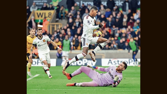 Marcus Rashford (centre) has sprung to life, as has the rest of Manchester United, under new coach Erik ten Hag. Below, United play the Wolverhampton Wanderers, on December 31. (Reuters)