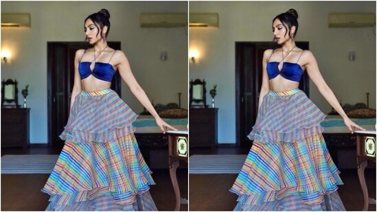Sobhita looked every bit gorgeous in the blue silk blouse with a plunging neckline, halter-neck and slip details, and backless patterns. She teamed it with a long tiered and checkered organza skirt featuring multicoloured shades. (Instagram/@sobhitad)