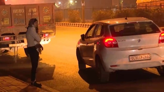 In a video clip going viral on social media, DCW chief Swati Maliwal is seen being harassed by a car driver and he drags her with his car after she takes a hold of him.(Source: Twitter)