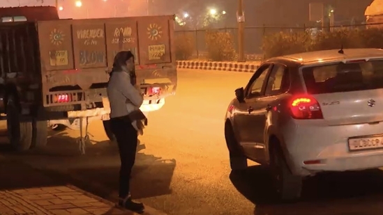 In a video clip going viral on social media, DCW chief Swati Maliwal is seen being harassed by a car driver and he drags her with his car after she takes a hold of him.(Source: Twitter)