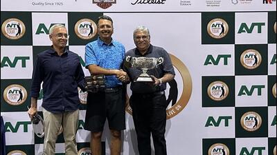 Chandigarh golfer SandeepSandhu (centre) receiving the trophy from the organisers. (HT Photo)