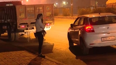 In a video clip going viral on social media, DCW chief Swati Maliwal is seen being harassed by a car driver and he drags her with his car after she takes a hold of him. (Source: Twitter)