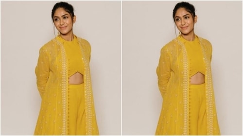 Mrunal decked up in a yellow cropped top with a closed halter neck and midriff-baring details. (Instagram/@mrunalthakur)