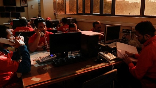 Volunteers of the Edhi Foundation, a non-profit social welfare programme, work at a communication and control room during a country-wide power breakdown in Karachi, Pakistan January 23, 2023.(Reuters)