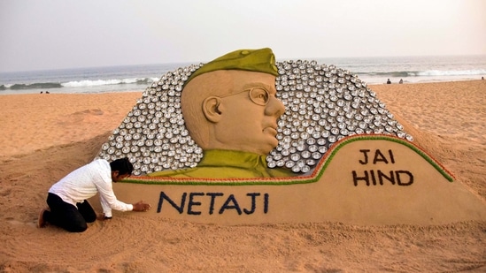 Sand artist Sudarsan Pattnaik creates a sand sculpture of Subhash Chandra Bose with installation of 450 steel bowls celebrating Bose's birth anniversary, at Puri beach in Puri.(PTI)