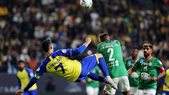 Cristiano Ronaldo in action with Al Ettifaq's Saeed Al-Mowalad(REUTERS)