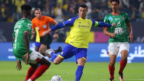 Al Nassr's Portuguese forward Cristiano Ronaldo (C) attempts a shot during the Saudi Pro League football match between Al-Nassr and Al-Ettifaq at the King Fahd Stadium in the Saudi capital Riyadh.(AFP)