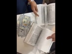 Over $90,000 cash was found concealed within pages of a book.(ANI) Over $90,000 cash was found concealed within pages of a book.(ANI)