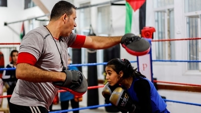 A 15-year-old Palestinian girl, Farah Abu Al-Qomsan, trains with coach Ayoub inside the Palestine Boxing Center, on January 17. "The girls are ready. I trained them hard for five years," Ayoub told Reuters. "We are setting an example." (Mohammed Salem / REUTERS) A 15-year-old Palestinian girl, Farah Abu Al-Qomsan, trains with coach Ayoub inside the Palestine Boxing Center, on January 17. "The girls are ready. I trained them hard for five years," Ayoub told Reuters. "We are setting an example." (Mohammed Salem / REUTERS)