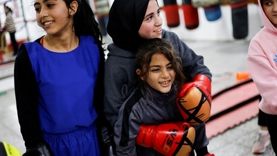 Farah and other young Palestinian women seen at the Palestine Boxing Center, on January 17. "Some people used to tell me 'Why boxing, what are you going to benefit from it, go and learn something girly'," Farah told Reuters. "I benefit a lot from boxing and today my ambition is to represent my Palestinian people and take part in world championships." (Mohammed Salem / REUTERS) Farah and other young Palestinian women seen at the Palestine Boxing Center, on January 17. "Some people used to tell me 'Why boxing, what are you going to benefit from it, go and learn something girly'," Farah told Reuters. "I benefit a lot from boxing and today my ambition is to represent my Palestinian people and take part in world championships." (Mohammed Salem / REUTERS)