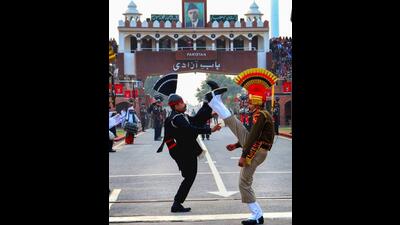 Border Security Force personnel (brown uniform) and Pakistani Rangers (black uniform) take part in the beating retreat ceremony at the Attari-Wagah border post, in Amritsar. (PTI)