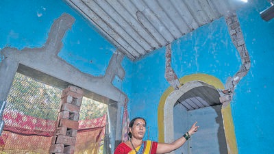 Mumbai, India - Jan. 24, 2023: Nalini Mali showing cracks on the house, Construction of the Mumbai-Vadodara Expressway about 4kms from Virar city, in Palghar district, has thrown the adivasi village if Khardi into a state of panic. Over the last three months, since an NHAI contractor began levelling a nearby hill to make way for the mega-project, between 25-30 homes have developed fresh (and large) cracks in their walls, beams and ceilings. Locals blame the incessant blasting just 200 metres away from their village. in Mumbai, India, on Tuesday, January 24, 2023. (Photo by Satish Bate/ Hindustan Times) (Hindustan Times) Mumbai, India - Jan. 24, 2023: Nalini Mali showing cracks on the house, Construction of the Mumbai-Vadodara Expressway about 4kms from Virar city, in Palghar district, has thrown the adivasi village if Khardi into a state of panic. Over the last three months, since an NHAI contractor began levelling a nearby hill to make way for the mega-project, between 25-30 homes have developed fresh (and large) cracks in their walls, beams and ceilings. Locals blame the incessant blasting just 200 metres away from their village. in Mumbai, India, on Tuesday, January 24, 2023. (Photo by Satish Bate/ Hindustan Times) (Hindustan Times)