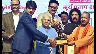 UP governor Anandiben Patel and chief minister Yogi Adityanath felicitate Noida DM and para- badminton player, Suhas LY with Laxman Award during the inaugural ceremony of the Uttar Pradesh Diwas, in Lucknow on Tuesday. Deputy chief minister Brajesh Pathak also seen. (ANI Photo) UP governor Anandiben Patel and chief minister Yogi Adityanath felicitate Noida DM and para- badminton player, Suhas LY with Laxman Award during the inaugural ceremony of the Uttar Pradesh Diwas, in Lucknow on Tuesday. Deputy chief minister Brajesh Pathak also seen. (ANI Photo)