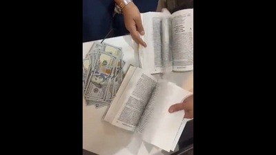 Over $90,000 cash was found concealed within pages of a book. (ANI) Over $90,000 cash was found concealed within pages of a book. (ANI)