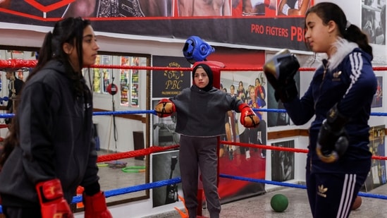 Young Palestinian women boxers during a practice session at the Palestine Boxing Center, in Gaza City, on January 17. Ayoub started the club with two girls. As more joined, they moved out of the garage and began training on the beach or in rented spaces before moving into the new club building, Reuters reported. (Mohammed Salem / REUTERS)