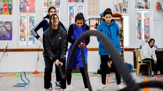 Young Palestinian women seen warming up during a training session at the Palestine Boxing Centre, on January 17. According to Reuters, around 40 girls train in the center with its full-size boxing ring, training equipment, and posters of boxing heroes such as Mike Tyson on the walls, defying expectations in a region where boxing has traditionally been a sport for men. (Mohammed Salem / REUTERS)