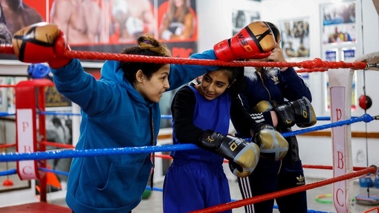 Teenage women boxers chat during a break from training at Gaza's first boxing center for women, on January 17. (Mohammed Salem / REUTERS)