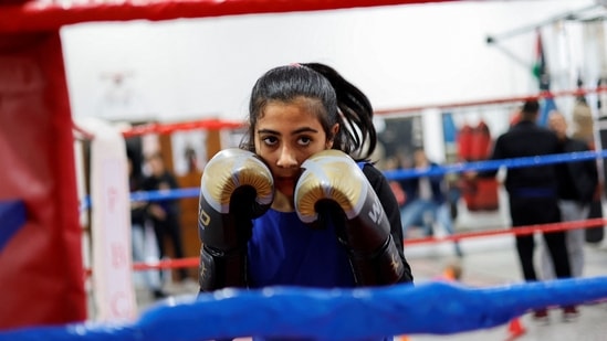 Farah Abu Al-Qomsan during a warm-up at the Palestine Boxing Center, on January 17. “We used to train in a small garage. Now we train according to the full rules and release bad energy," she tells Reuters. (Mohammed Salem / REUTERS)