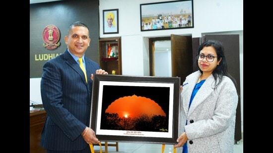 Deputy commissioner Surabhi Malik unveiling the pictorial work depicting sunrise of Punjab 2023 compiled by author, environmentalist and nature artist Harpreet Sandhu in Ludhiana on Tuesday. (HT Photo)