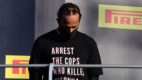 FILE PHOTO: Formula One F1 - Tuscan Grand Prix - Mugello, Scarperia e San Piero, Italy - September 13, 2020 Mercedes' Lewis Hamilton wears a shirt in reference to Breonna Taylor on the podium as he celebrates after winning the race Pool via REUTERS/Jennifer Lorenzini/File Photo(Pool via REUTERS)