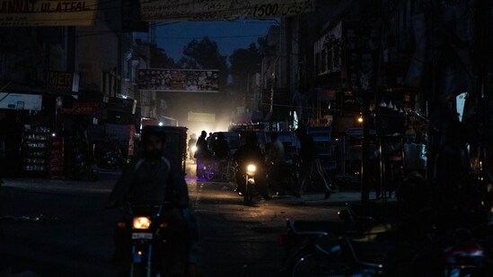A dark street in a commercial area in Lahore, Pakistan, on Monday, Jan. 23, 2023. Millions of people across Pakistans major cities were plunged into a blackout prompted by a power grid failure, dealing another blow to the nation already reeling from surging energy costs. Photographer: Betsy Joles/Bloomberg