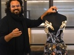In this photograph taken on January 13, 2023, Indian fashion designer Rahul Mishra stands beside his new collection at his workshop in Noida. - For a man with seemingly infinite creative ambitions, it is fitting that Indian designer Rahul Mishra's latest Paris haute couture collection attempts to encapsulate the entire universe. (Photo by Money SHARMA / AFP)(AFP) In this photograph taken on January 13, 2023, Indian fashion designer Rahul Mishra stands beside his new collection at his workshop in Noida. - For a man with seemingly infinite creative ambitions, it is fitting that Indian designer Rahul Mishra's latest Paris haute couture collection attempts to encapsulate the entire universe. (Photo by Money SHARMA / AFP)(AFP)