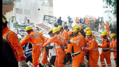 Rescue operation underway after the collapse of a four-storey residential building on Wazir Hasan Road in Lucknow on Wednesday. (PTI Photo)