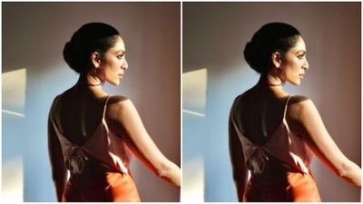 Sobhita looked every bit amazing in the bright orange slip gown with ivory white patterns at the neckline. The gown featured a plunging neckline and a knot detail at the back.&nbsp; (Instagram/@sobhitad)
