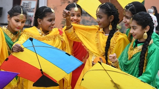 School girls prepare kites to fly as they celebrate the Hindu festival of Basant Panchami at a school in Amritsar. Here's why Hindu devotees wear yellow clothes for Saraswati Puja (Photo by Narinder NANU / AFP)