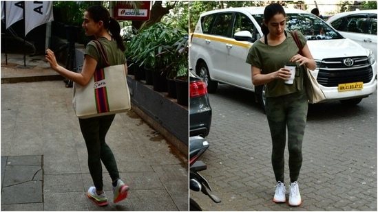 Sara Ali Khan wore a green-toned outfit to hit the gym. The star served workout fashion inspiration for her fans in the comfy and fuss-free look featuring a round-neck tee and printed yoga tights. The tee comes with half-length sleeves and a loose fitting.&nbsp;(HT Photo/Varinder Chawla)