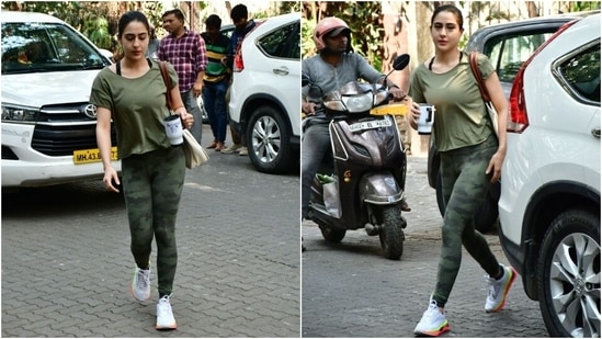 Sara's tights feature a green camouflage print and figure-hugging fitting. She accessorised the gym outfit with white and neon orange-coloured chunky lace-up sneakers, a coffee mug, and a cool personalised tote bag with her name printed on it.&nbsp;(HT Photo/Varinder Chawla)
