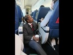 Delta flight attendant Floyd Dean-Shannon comforting a distressed passenger. (Facebook/Molly Simonson Lee) Delta flight attendant Floyd Dean-Shannon comforting a distressed passenger. (Facebook/Molly Simonson Lee)
