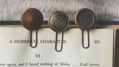 Buttons: Buttons can be used as bookmarks by simply threading a paperclip through the buttonhole and securing it in place. This is a great way to use buttons from old clothes or shirts that are no longer wearable. (Pinterest) Buttons: Buttons can be used as bookmarks by simply threading a paperclip through the buttonhole and securing it in place. This is a great way to use buttons from old clothes or shirts that are no longer wearable. (Pinterest)