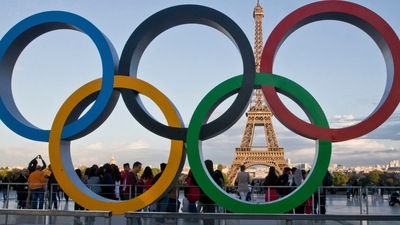 FILE - The Olympic rings are set up at Trocadero plaza that overlooks the Eiffel Tower, a day after the official announcement that the 2024 Summer Olympic Games will be in the French capital, in Paris, Thursday, Sept. 14, 2017. The budget for the 2024 Paris Olympics is expected to go up by 10%, in part because of high inflation, organizers said Tuesday, Nov.22, 2022. The organizing committee, known as COJO, had an original budget of around 4 billion euros ($4.1 billion) but will present a revised figure at a board meeting next month that is expected to reach 4.4 billion euros ($4.5 billion). (AP Photo//Michel Euler, File) (AP)