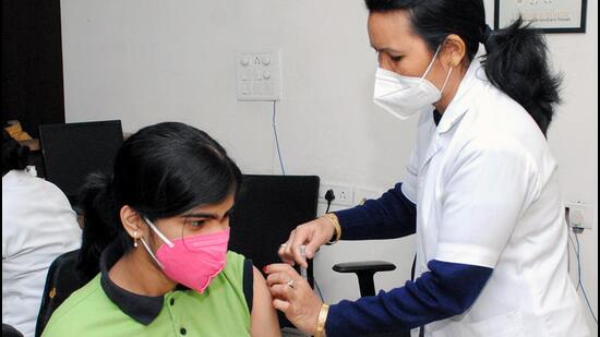 A health care worker inoculates a beneficiary with a booster dose of Covid-19 vaccine at Gauhati Medical College and Hospital (GMCH), in Guwahati. (ANI)