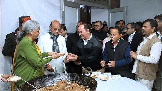 Union finance minister Nirmala Sitharaman distributes halwa to the members of Budget Press during the halwa ceremony ahead of the lock in process of the Budget preparation, in New Delhi on Thursday. (ANI) Union finance minister Nirmala Sitharaman distributes halwa to the members of Budget Press during the halwa ceremony ahead of the lock in process of the Budget preparation, in New Delhi on Thursday. (ANI)