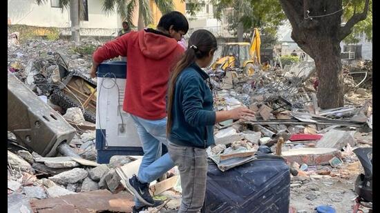 Residents retrieving their household items from the debris on Friday. (Sourced)