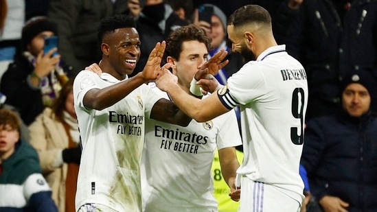 Real Madrid's Vinicius Junior celebrates scoring their third goal with Karim Benzema and a teammate(REUTERS)